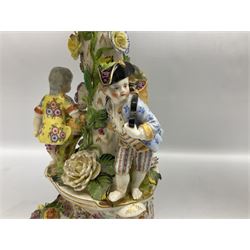 Pair of late 19th/early 20th century Continental table centre pieces, each modelled with a floral encrusted column flanked by three male and female figures with baskets of flowers, supporting a part pierced and floral encrusted bowl with hand painted floral sprays to the interior, the whole upon a conforming pierced and encrusted base with three scroll feet, each with indistinct blue mark beneath, H46cm bowl D31.5cm 