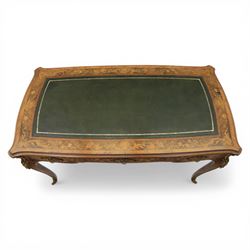 Late 19th century French kingwood and marquetry bureau plat, the serpentine rectangular top with green leather inset writing surface within crossbanded and foliate marquetry border, above a shaped frieze fitted with three drawers with floral marquetry panels and gilt metal handles, upon cabriole supports with applied gilt metal mounts and sabots