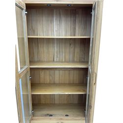 Light oak bookcase display cabinet, fitted with two glazed doors, drawer to base