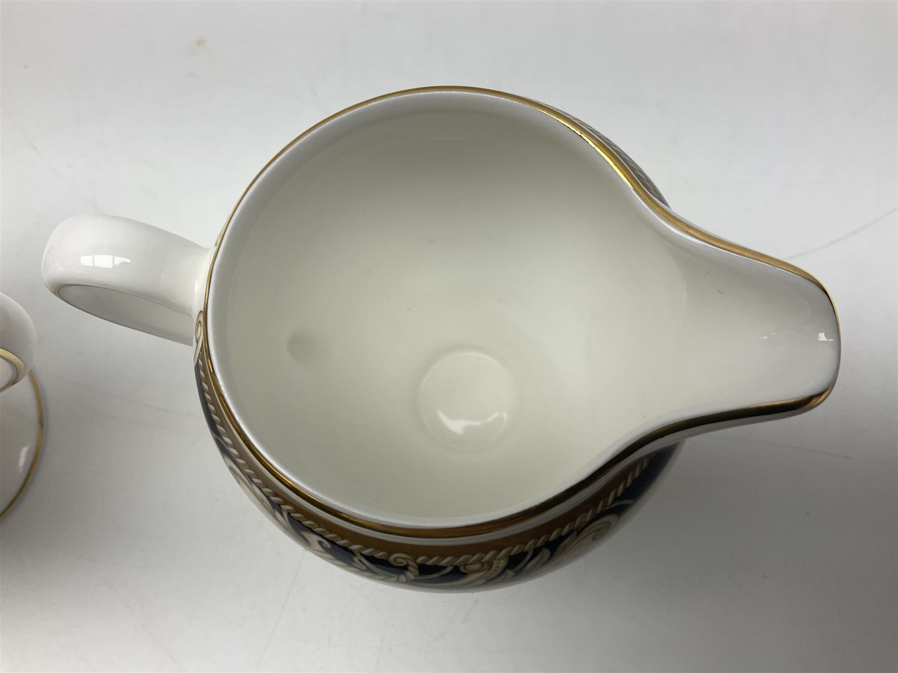 Wedgwood Cornucopia coffee service for six, comprising coffee pot, milk jug, twin handled covered sucrier, coffee cans and saucers