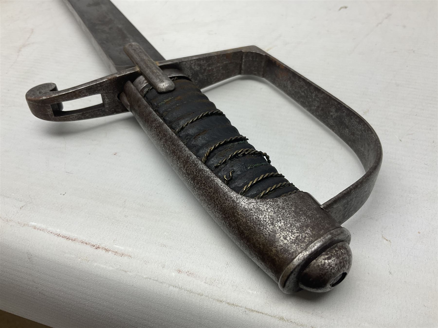 Italian M1833 Sabre with slightly curving 79cm fullered steel blade, the plain steel hilt with 'D' shaped knuckle bow, langets and wire-bound leather grip; in steel scabbard with single hanging ring L101cm overall