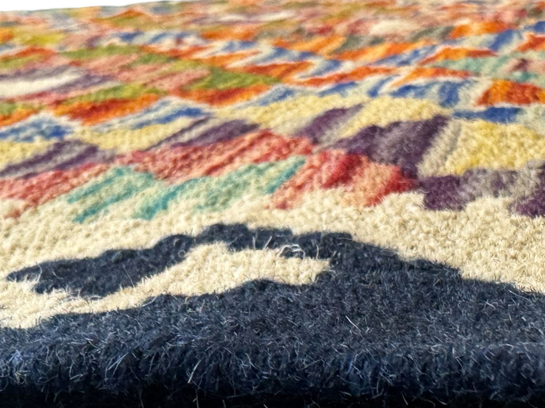 Chobi Kilim flatweave rug, dark navy ground with a vibrant multicoloured diamond lattice, framed by stylised border motifs, braided corner tassels