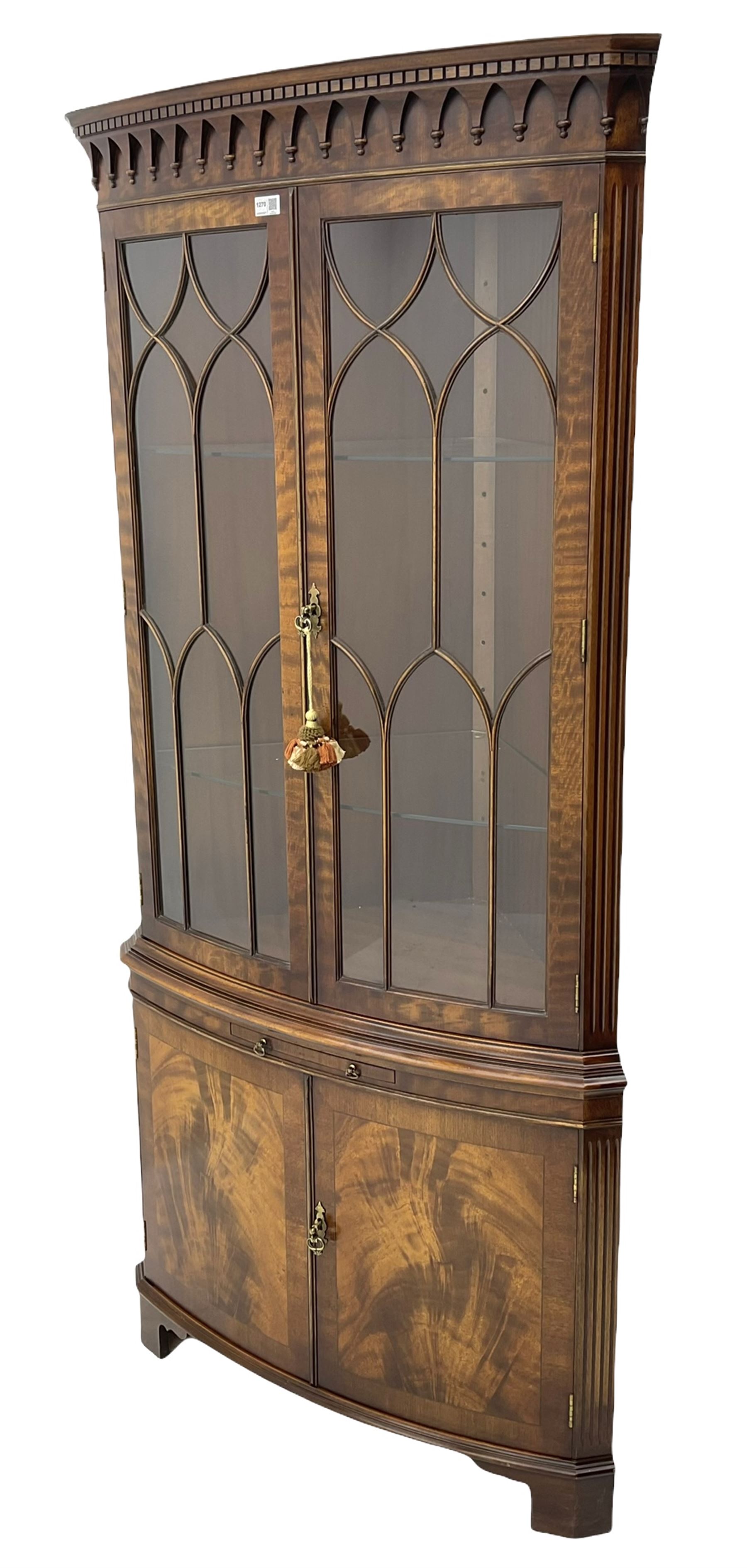 Bevan Funnell 'Reprodux' Georgian style figured mahogany bow front double corner display cabinet, two glazed doors above drinks slide and two cross-banded doors