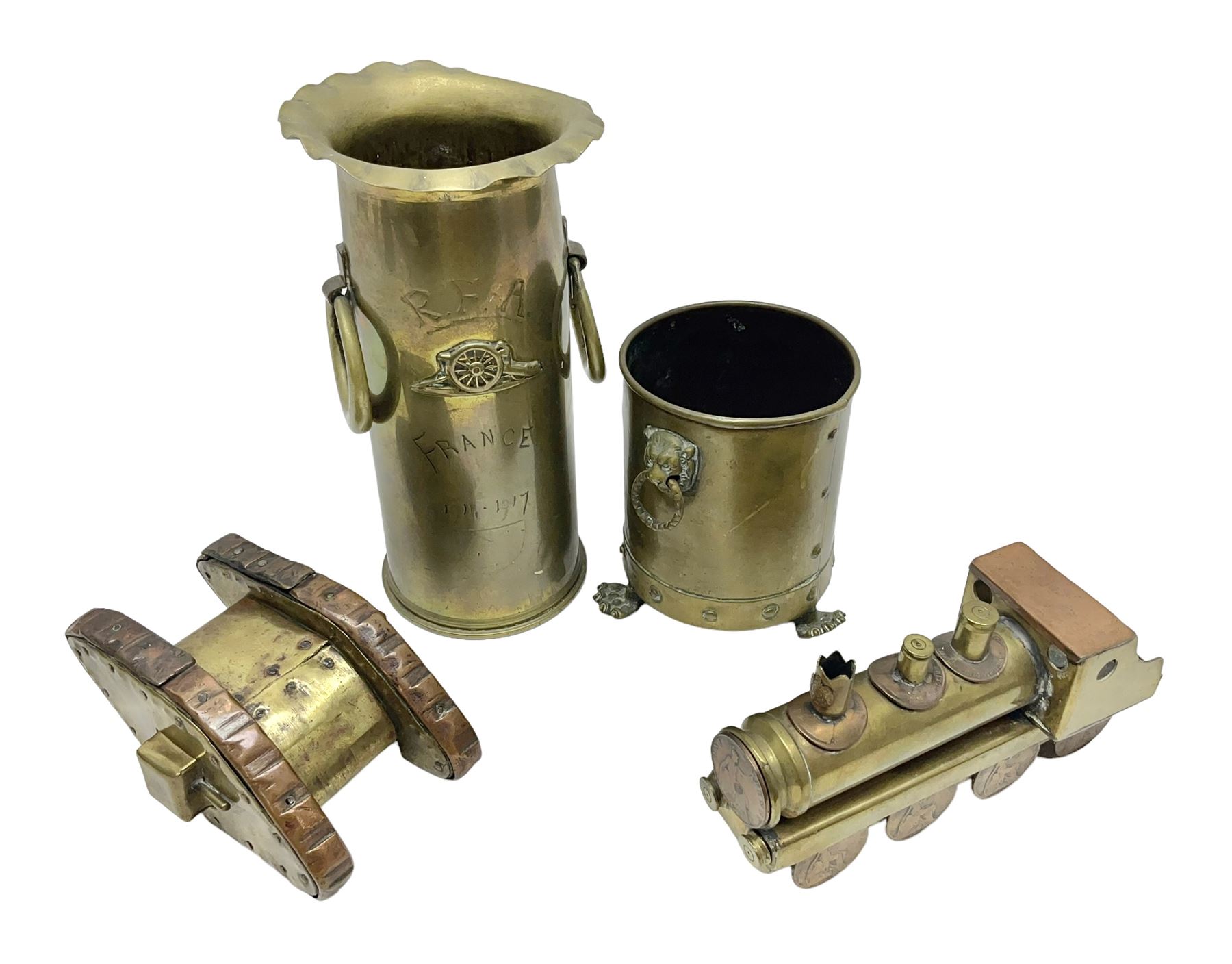 Trench Art - WWI 0-8-0 steam locomotive made from brass, copper and late Victorian pennies and half-pennies L17.5cm; WWI brass and copper tank candleholder; WWI brass shell case two-handled vase inscribed 'RFA France 1914-17'; and an unrelated brass plant holder (4)