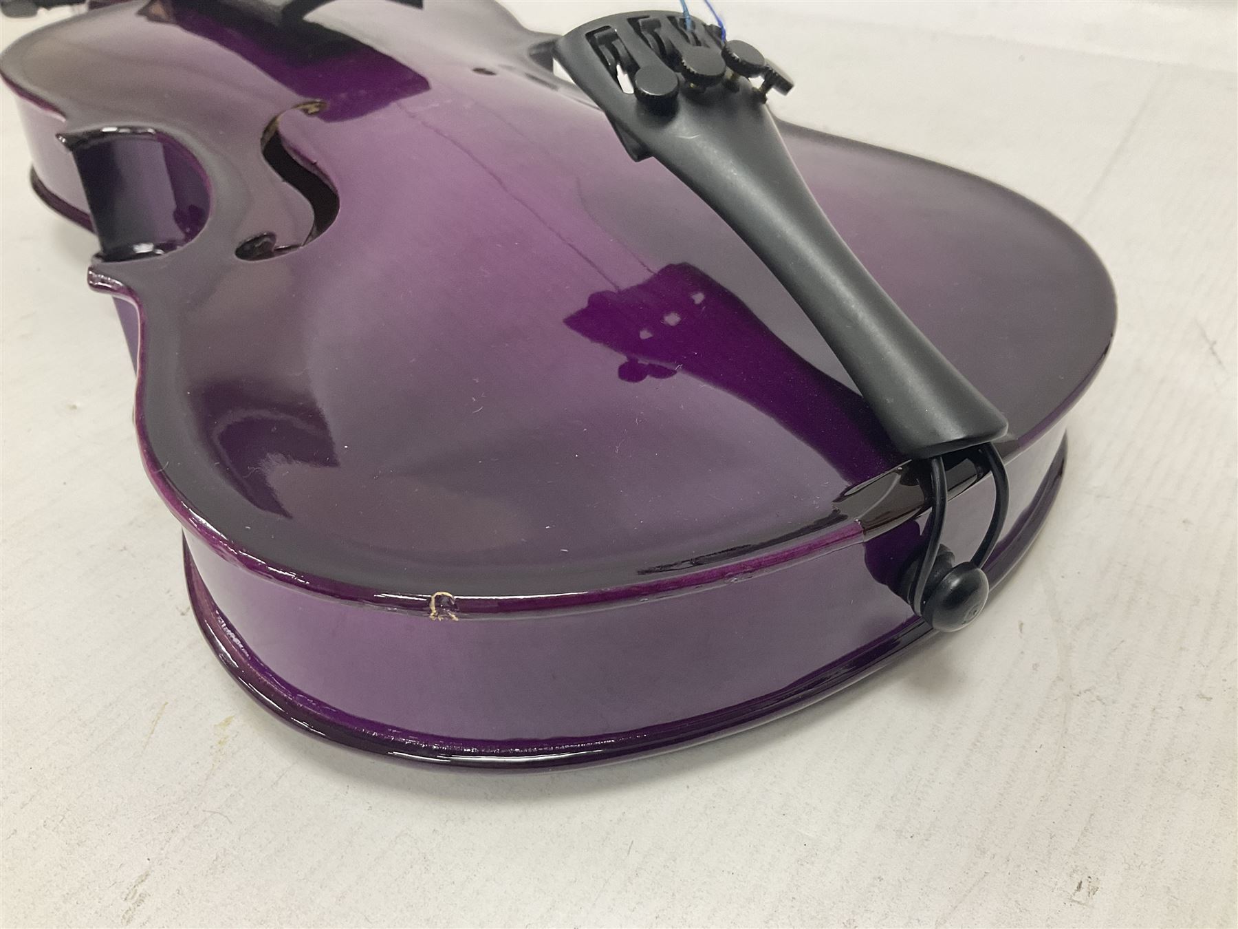 Intermusic 3/4 violin with a violet coloured solid wood body, ebonised fingerboard and fittings, bow and hard case, length 54cm