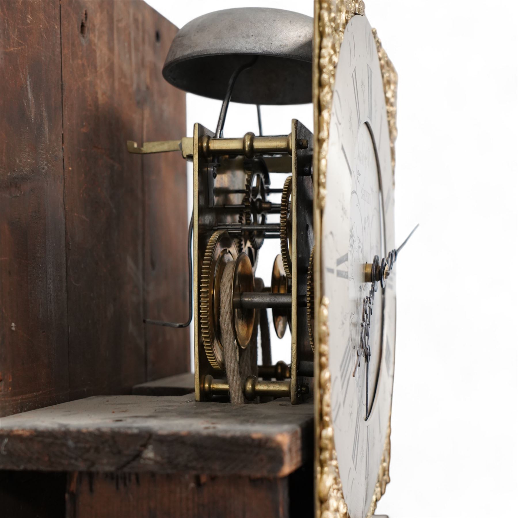 Neddy Wells of Shepley-18th century oak cased 30 hour longcase clock c 1760, with a swan necked pediment and two gesso ball and spire finials, square trunk door flanked by plain turned pilasters with gesso capitals, trunk with recessed quarter columns and a long trunk door, square plinth raised on bracket feet, with a brass dial, cast spandrels, silvered and engraved dial centre with makers name and calendar dial, chapter with Roman numerals, five minute Arabic's and matching steel hands, rope driven countwheel movement striking the hours on a bell. With weight and pendulum. 
Neddy Wells is recorded as working at Shepley near Huddersfield c1720-80.