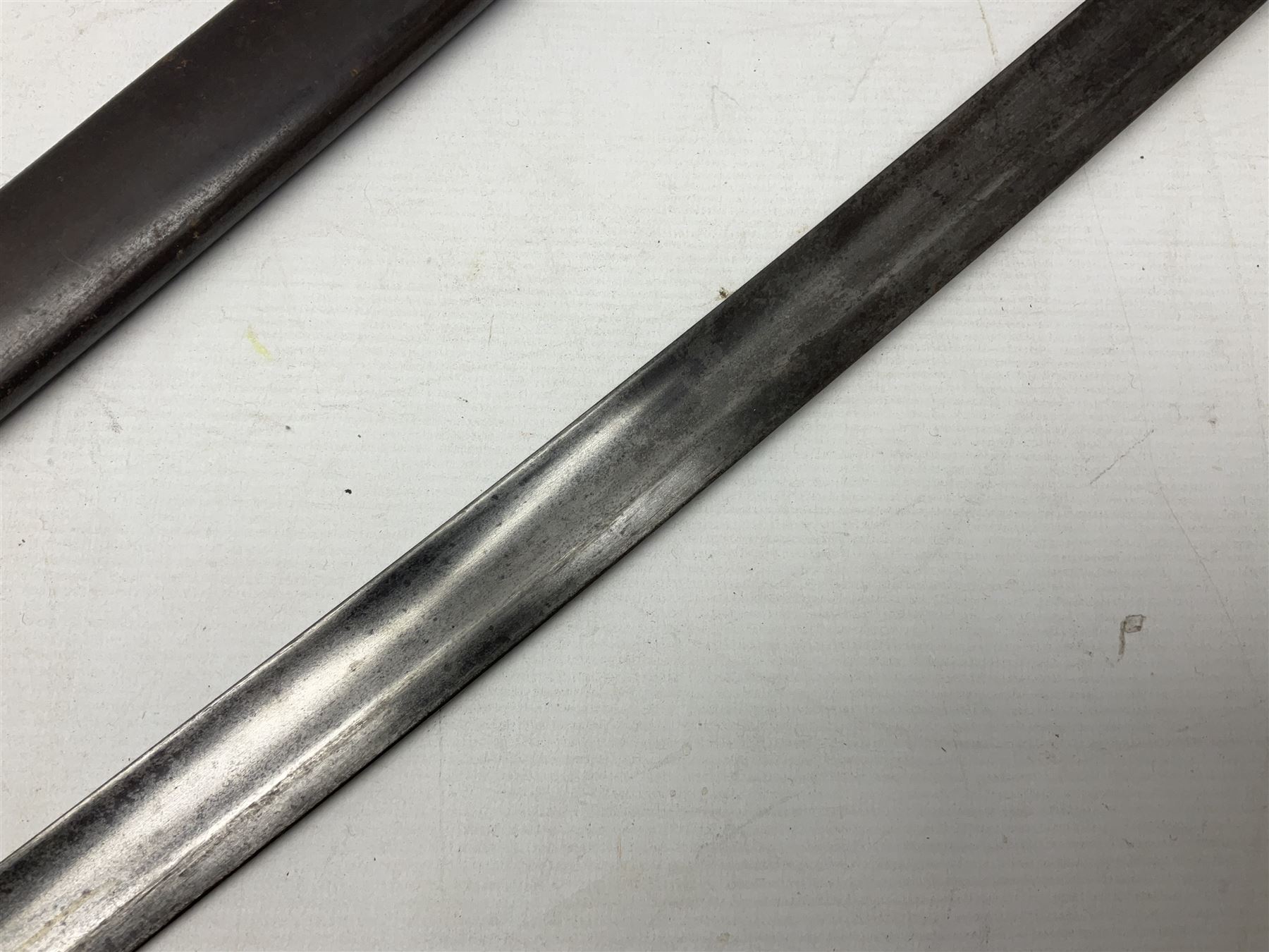 Italian M1833 Sabre with slightly curving 79cm fullered steel blade, the plain steel hilt with 'D' shaped knuckle bow, langets and wire-bound leather grip; in steel scabbard with single hanging ring L101cm overall