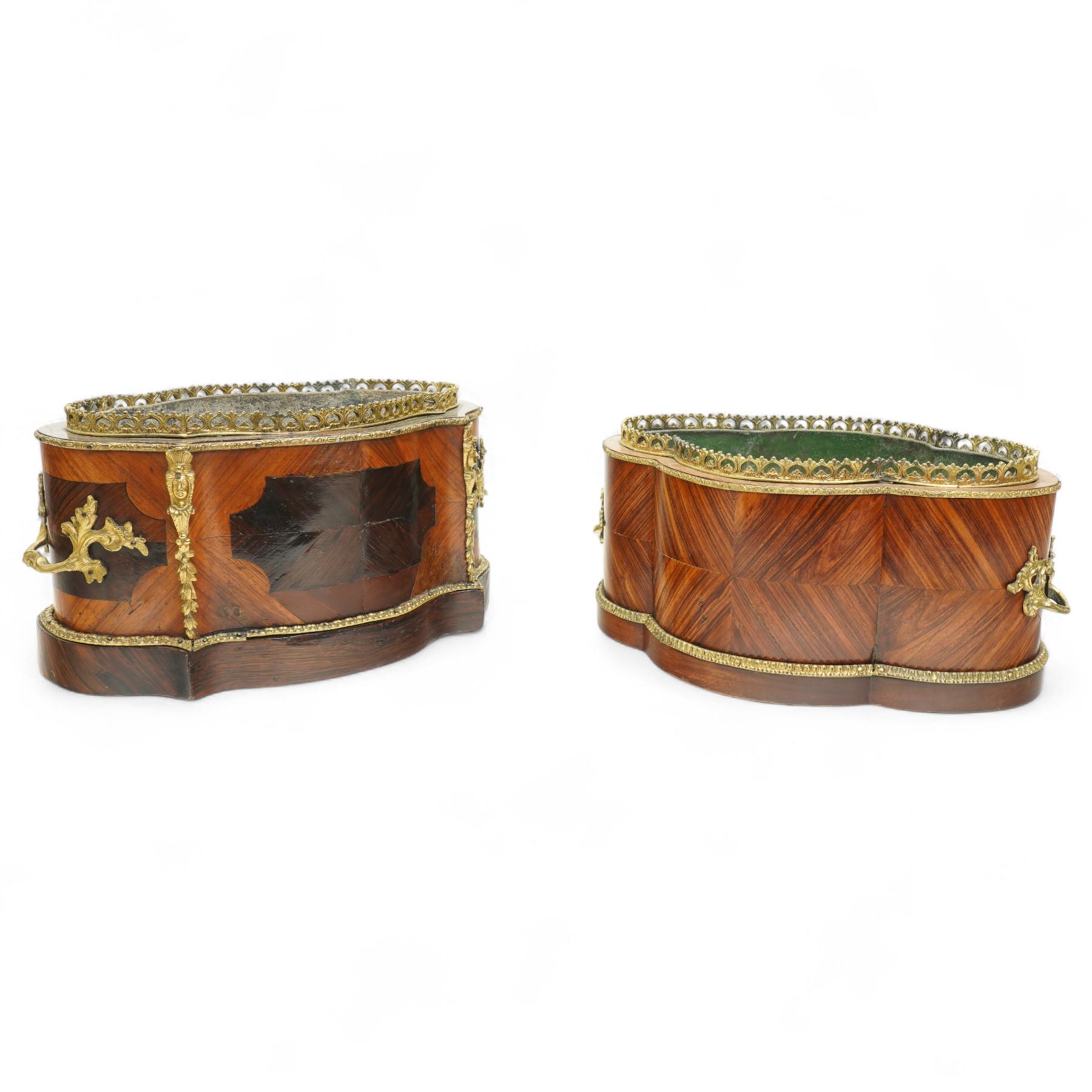 Matched pair of 19th-century French Kingwood and gilt brass mounted table jardinières, quatrefoil-shaped form with original zinc liners, foliate gilt brass mounted pierced gallery above kingwood crossbanded sides and inset serves style porcelain plaque and gilt brass carrying handles on plinth base