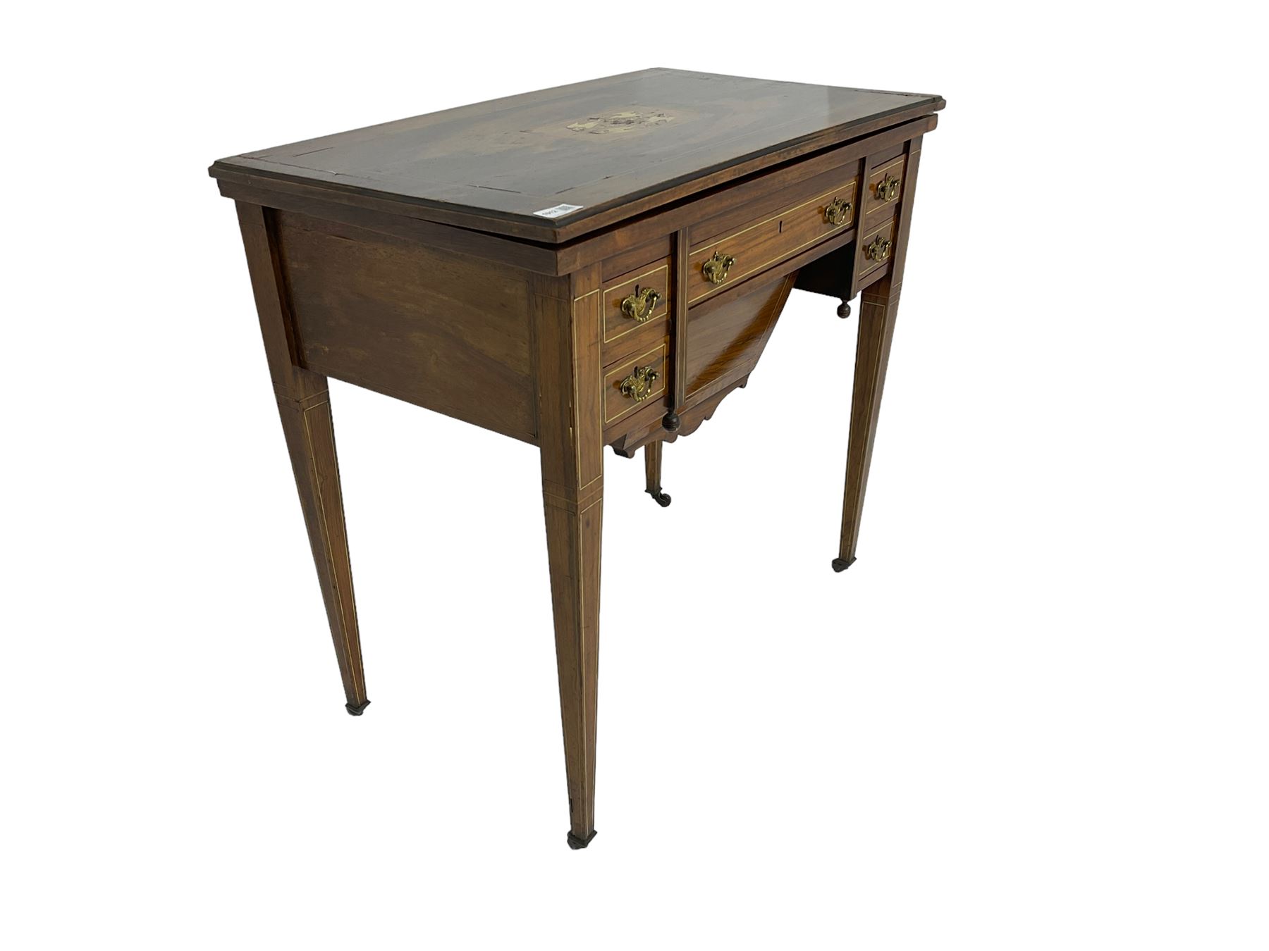 Edwardian inlaid mahogany games or work table, rectangular fold-over top inlaid with stylised dragon ivorine decoration and stringing, fitted with one long flanked by four small drawers over sewing compartment drawer, raised on square tapering supports with castors