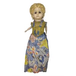Victorian large wax over composition Pumpkin head doll, with inset dark glass eyes, moulded blonde hair in curls, stuffed body with carved and painted wooden limbs, grey painted boots, floral satin dress with netting underclothes H61cm
