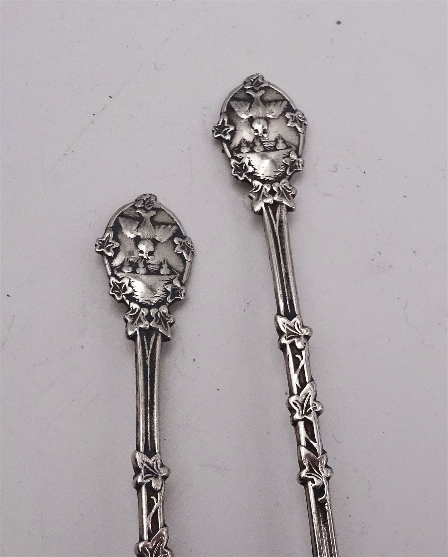 Gorup of silver, comprising pair of Edwardian silver napkin rings, with repousse floral decoration, hallmarked E J Trevitt & Sons, Chester 1903, together with set of three 1930s silver Hanoverian pattern coffee spoons, each with rattail bowls and engraved initial to terminals, hallmarked Frank Cobb & Co Ltd, Sheffield 1936, a pair of early 20th century coffee spoons, each embossed with nesting birds to terminals, with ivy leaf borders and stems, hallmarked Robert James Chaplin & Sons, London 1919, and a Siamese silver mounted cigarette box, with niello work dragon boat scene to cover, lifting to reveal wood lined interior, stamped Sterling Siam, H3.2cm W9.7cm