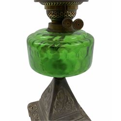Late Victorian oil lamp, the cast metal base decorated with foliate tendrils, supporting a green glass reservoir, and opaque glass shade and clear class chimney, H60cm. 