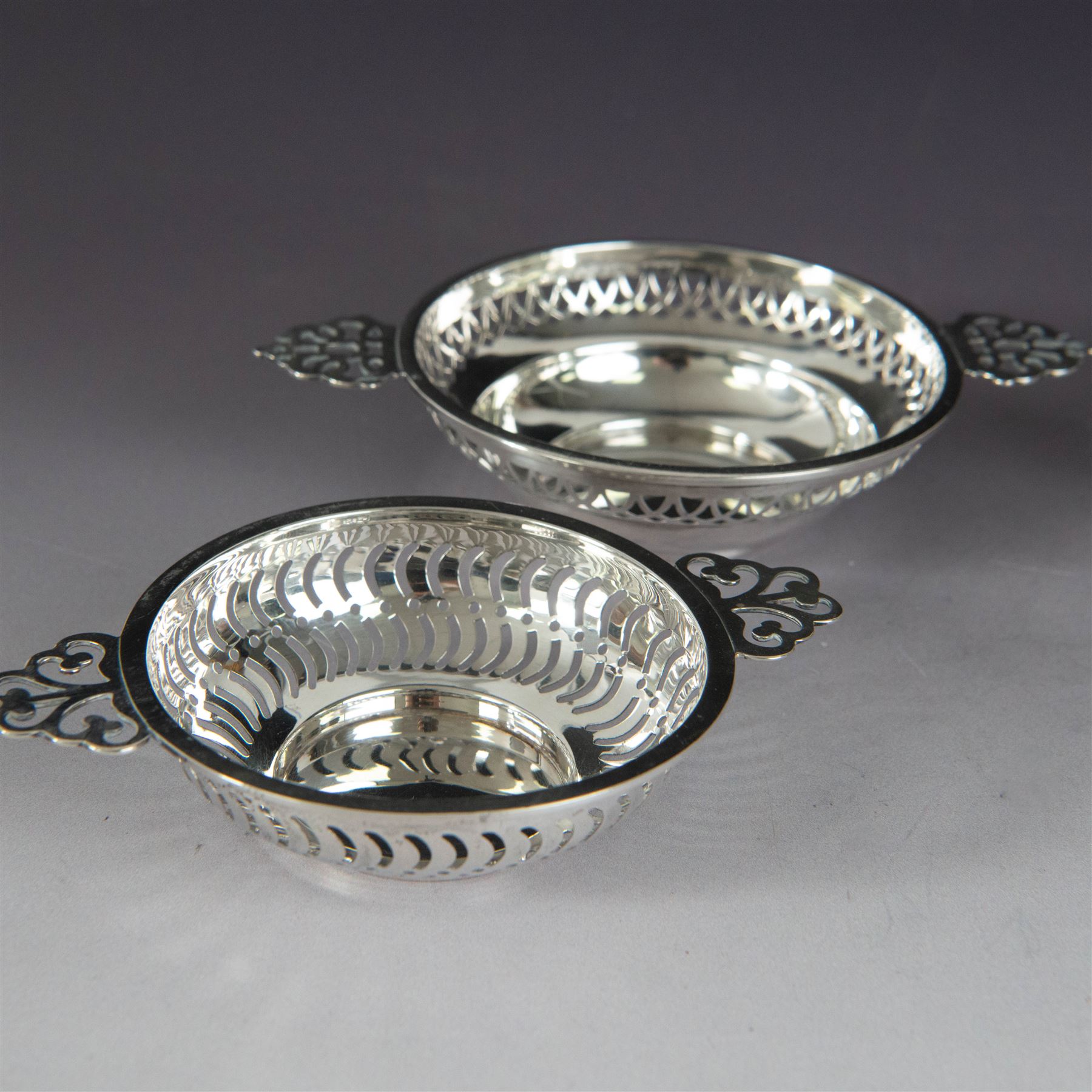 Two pairs of Victorian silver bon bon dishes, modelled as quaiches with pierced sides and twin handles, the larger pair hallmarked Synyer & Beddoes, Birmingham 1913 or 1938, the smaller pair hallmarked Birmingham 1913 or 1938, maker's marks worn and indistinct, largest D9cm