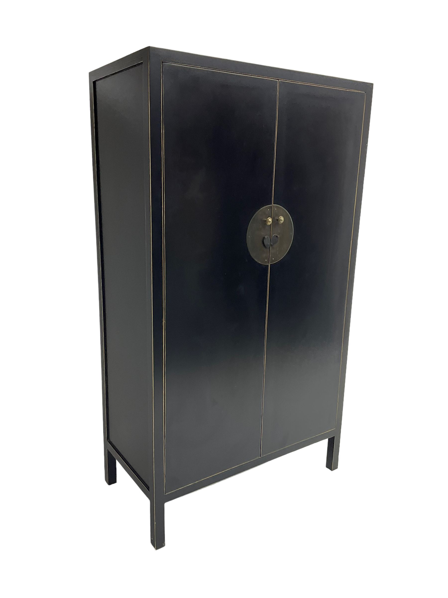 Chinese design black lacquered wardrobe, two cupboard doors enclosing hanging rail and two drawers