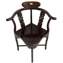 Chinese carved hardwood corner chair, outswept arms over pierced and carved floral splats, raised on shaped cylindrical supports united by X-stretcher