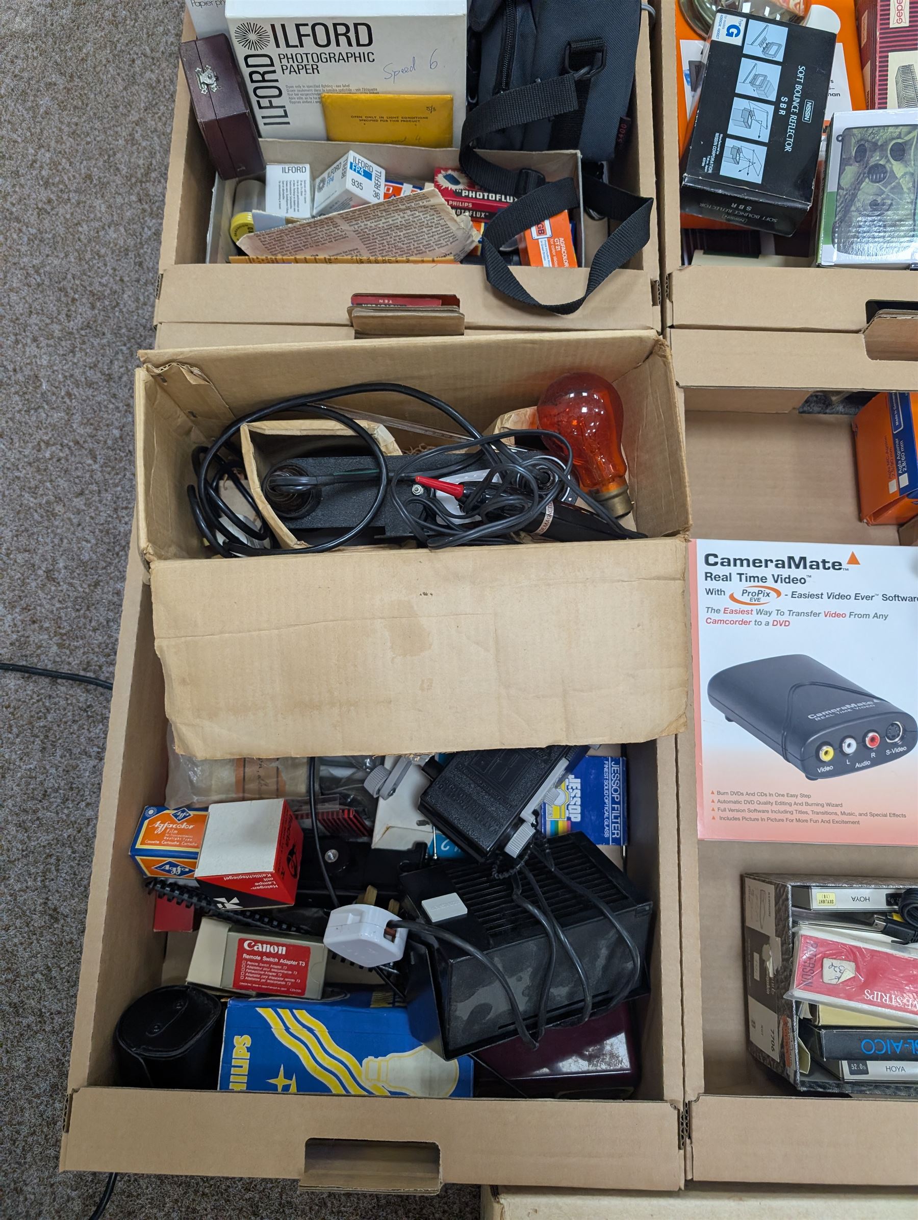 Large collection of photography equipment, including two video cameras JVC and a Panasonic 3CCD, tripods, filters, photograph paper, developing equipment, Dalite projector screen, etc, some boxed some empty boxes, and a Midgard Pocket Microscope