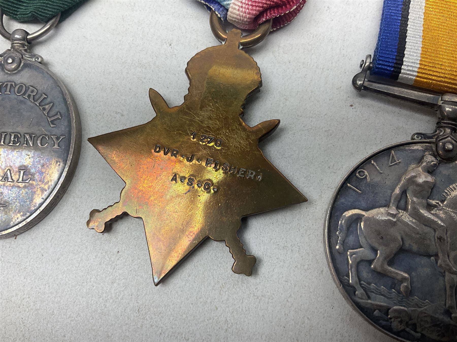 WW1 group of three medals comprising British War Medal, 1914-15 Star and Victory Medal awarded to 1270 Dvr. J. Fisher A.S.C.; and Territorial Efficiency Medal to T4-214571 Dvr. J. Fisher R.A.S.C.; all with ribbons (4)