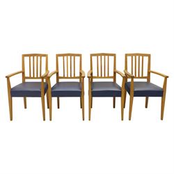 Modern twelve oak dining chairs including one 'Chairmans' chair, solid oak construction, slatted back and arm rests, blue leatherette padded seat, on tapered square supports 