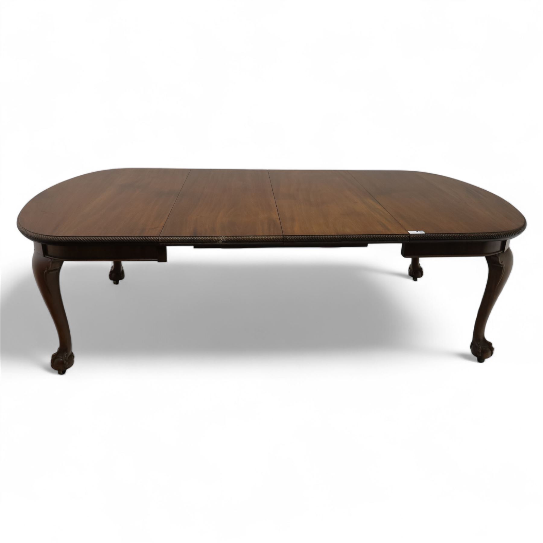 Early 20th century dining table, moulded oval top with gadroon carved edge, fitted with two additional leaves, raised on cabriole legs with shell carved knees and claw and ball feet