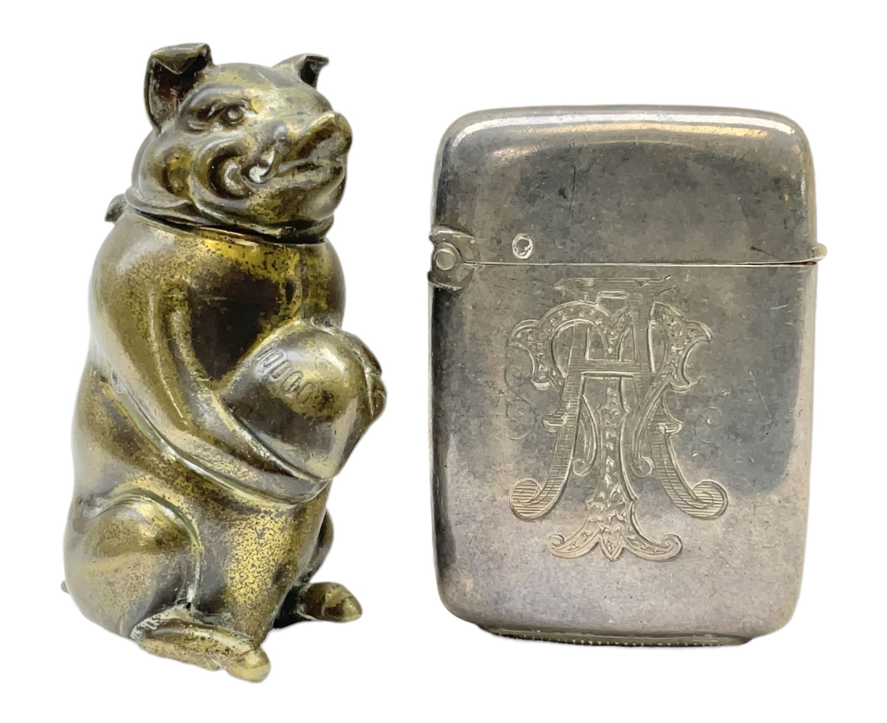 Victorian novelty brass vesta case modelled in the form of a pig holding a money bag, together with a silver vesta, hallmarked 