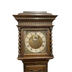 8-day oak longcase clock - in an early 18th century styled case with a caddy top, square hood door with barley twist columns, long carved trunk door on a conforming plinth with an applied skirting base, square brass dial with an engraved centre, silvered chapter and spandrels, 19th century rack striking movement, striking the hours on a bell. With weights and pendulum.