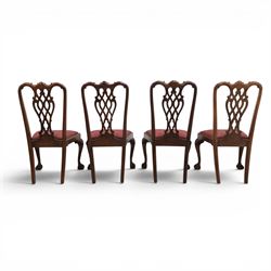 Chippendale design set of ten (8+2) mahogany dining chairs, serpentine cresting rails with carved detail over pierced ribbon-tied splats, red damask upholstered drop-in seats, on cabriole supports with acanthus carved knees and claw and ball feet