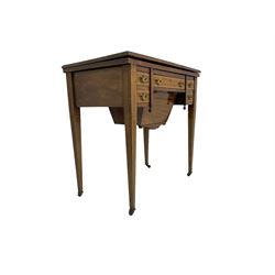 Edwardian inlaid mahogany games or work table, rectangular fold-over top inlaid with stylised dragon ivorine decoration and stringing, fitted with one long flanked by four small drawers over sewing compartment drawer, raised on square tapering supports with castors