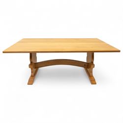Unicornman - Yorkshire oak rectangular refectory style dining table by Coxwold cabinet maker Geoff Gell, rectangular top above trestle form base with broad scrolling outward outline, and heavy arched stretcher with Unicornman carved motif, traditional mortice and tenon pegged joints between the uprights
