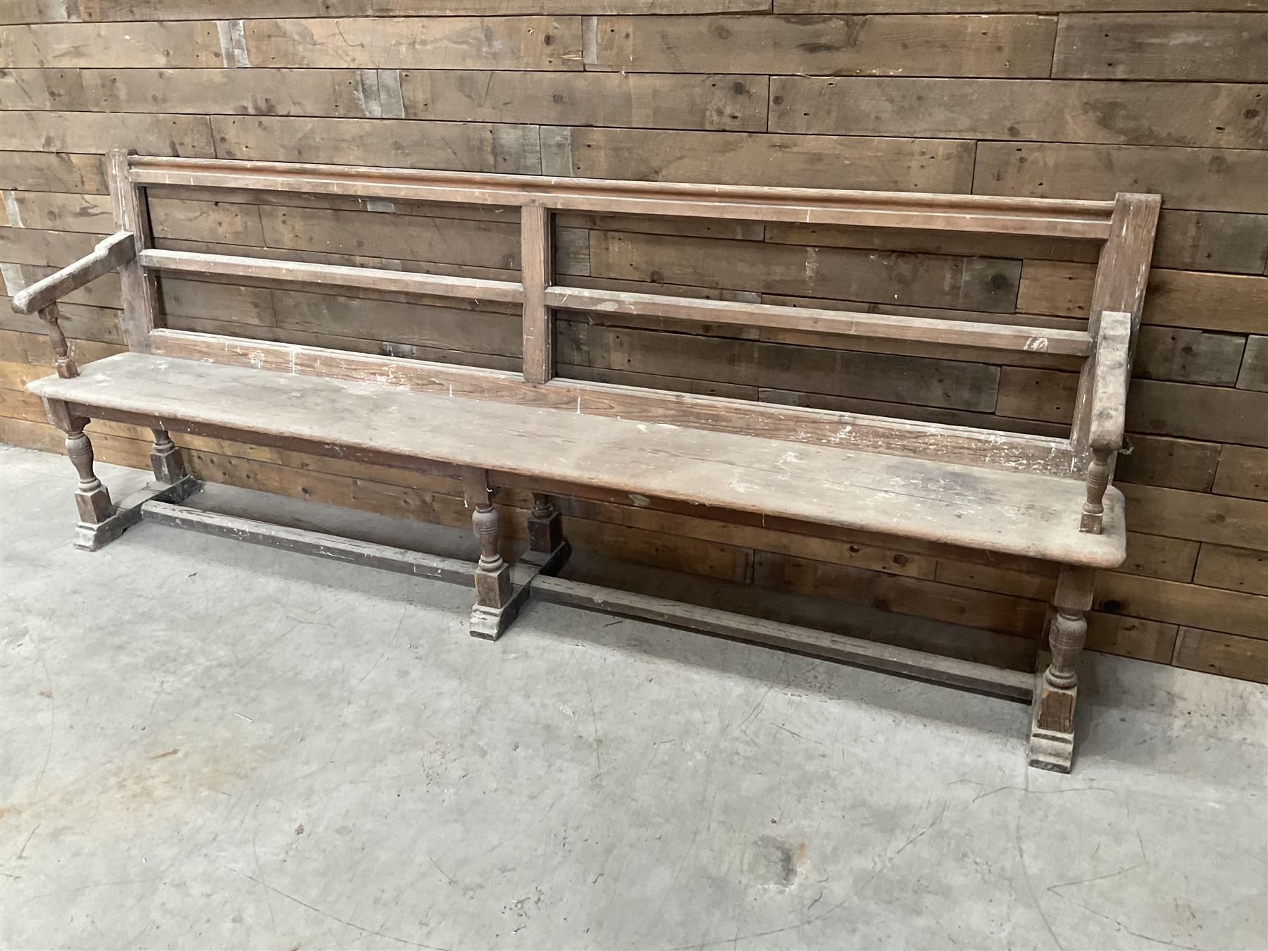 Victorian pitch pine bench pew, turned arms and legs, rail back with plank seat, 249cm