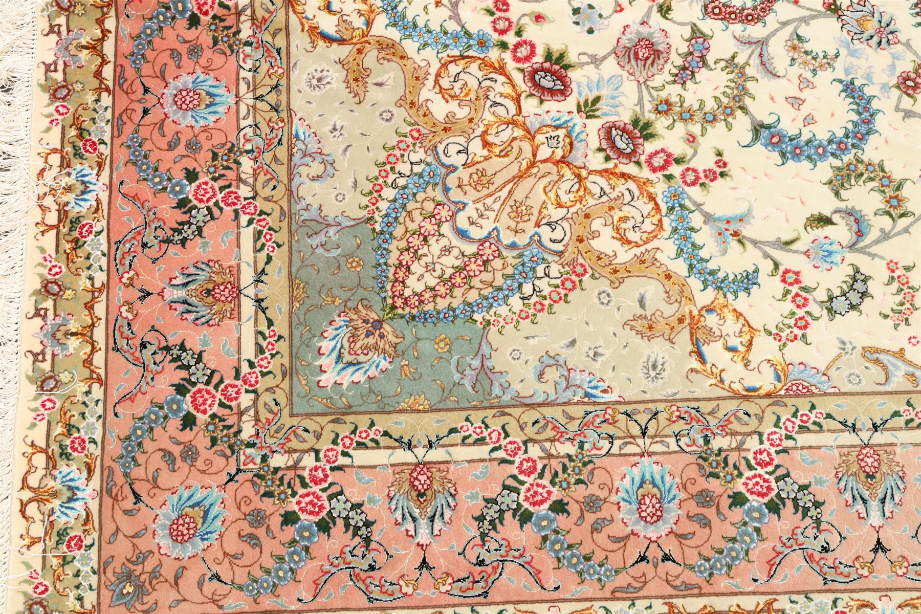 Fine Persian silk inlaid ivory and rose ground Tabriz rug, the busy field decorated with a central foliate pole medallion surrounded by scrolling foliage with trailing flowerheads and bouquets, the multiple guard lines filled with repeating scrolling palmettes and interlocking floral motifs