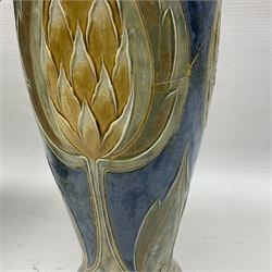 Early 20th century Royal Doulton stoneware vase, decorated with a stylized floral design below a wavy rim, monogrammed B.N, possibly for Bessie Newbery, H28cm, together with an early 20th century glazed jug, heavily carved throughout (2)