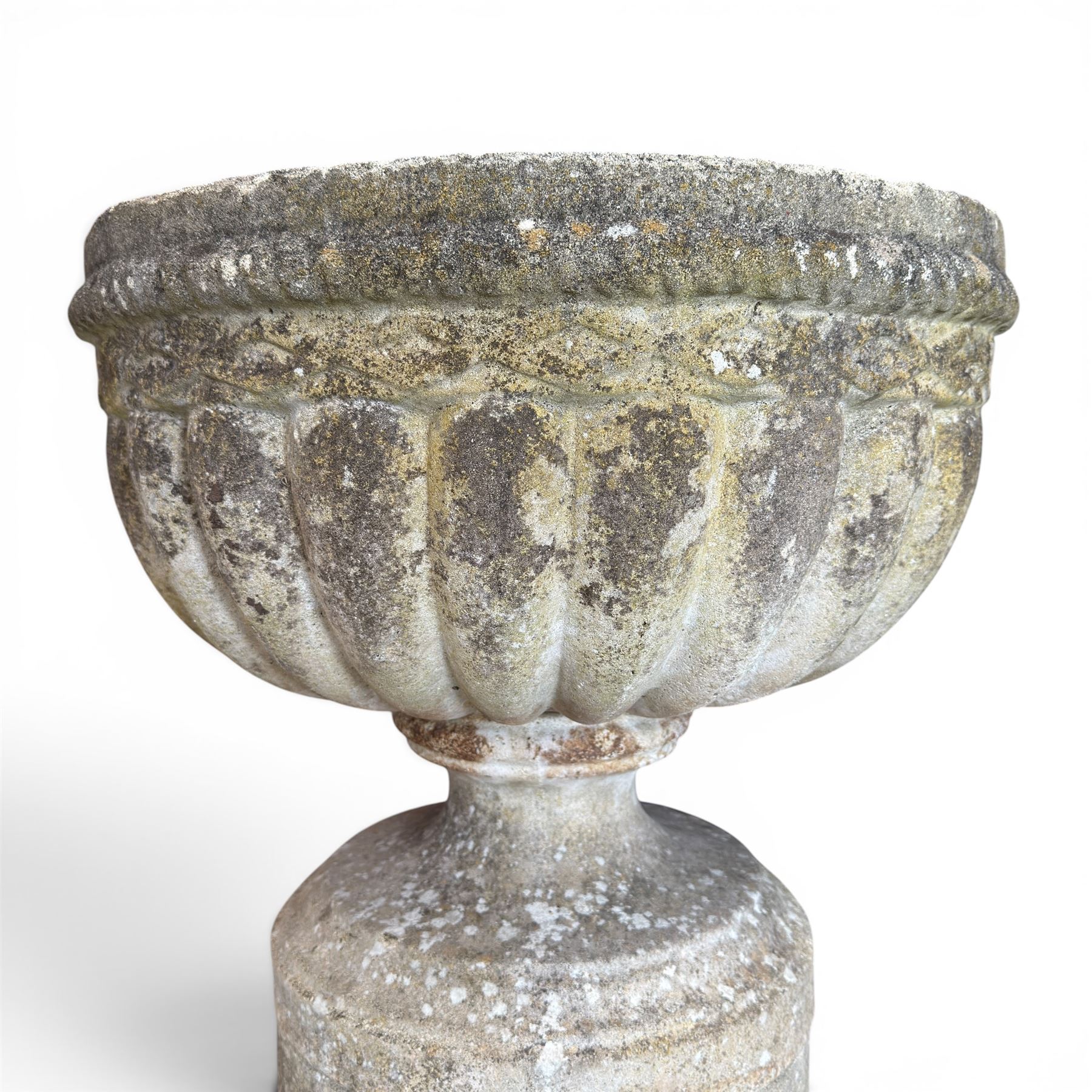 20th century good quality weathered cast stone pedestal urn of ecclesiastical design, circular lobed bowl with rope twist and lattice border, raised on squat base with fluted column  and acanthus decorated base