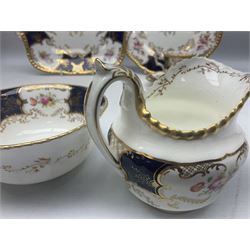 Coalport cobalt blue batwing pattern tea wares, decorated with finely enamelled floral sprays within gilt reserves, comprising teacup trio, coffee can and saucer and other cup and saucer, twin handled cake plate, milk jug and open sucrier, and circular plate retailed by T. Goode & Co London, pattern no Y2665,  all with green Coalport AD 1750 marks beneath, largest W26cm (11)