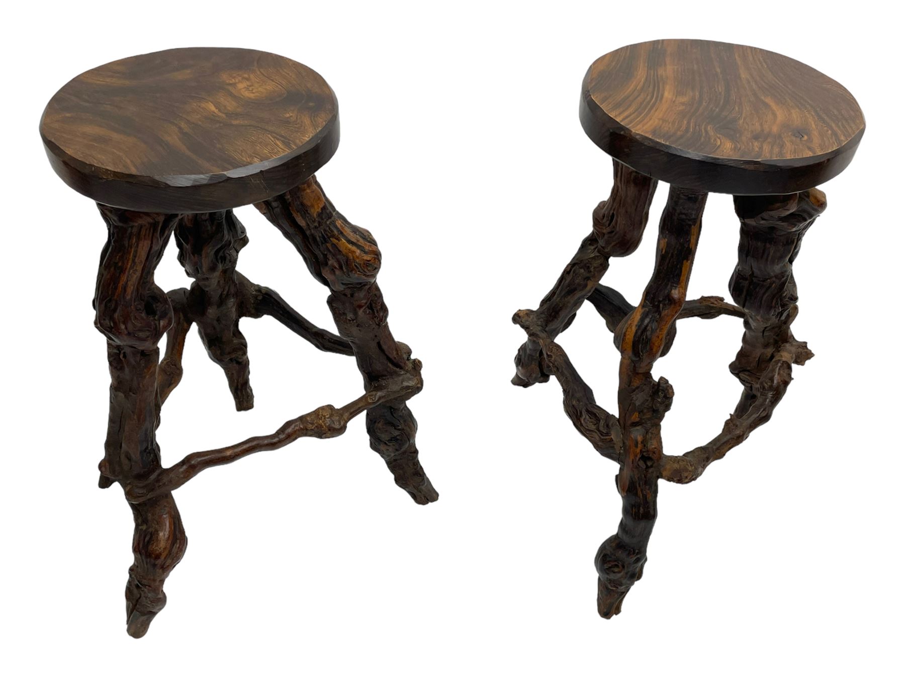 Mid-20th century French grapevine and walnut bow-front wine tasting bar, the curved counter top supported by sculptural grapevine roots, fitted with single shelf and raised on rustic vine feet (W100cm H101cm); with a pair of matching bar stools, the circular top raised on three gnarled root supports united by stretchers (W50cm H70cm)