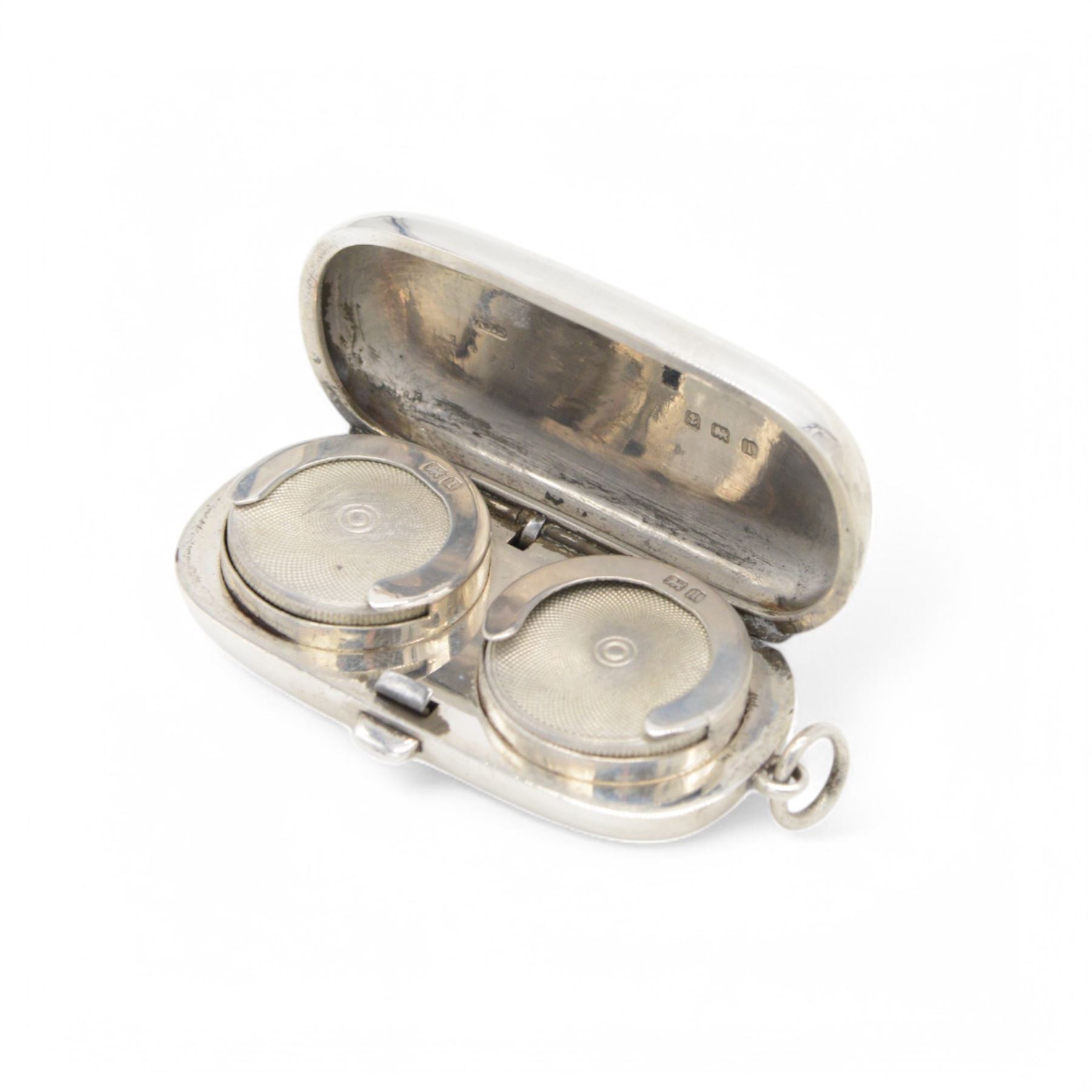 Edwardian silver sovereign holder, of plain oval form, the hinged cover opening to reveal two spring loaded recesses, hallmarked Dennison Watch Case Co, Birmingham 1910, L5.5cm