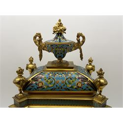 19th century French ormolu and champlevé enamel mantel clock, the twin handled urn with fruit and flower cast finial on cushion top, each corner set with urn, the front canted corners decorated with winged caryatid figures, turquoise ground champlevé work with scrolling floral pattern, twin train movement striking on bell by Japy Freres