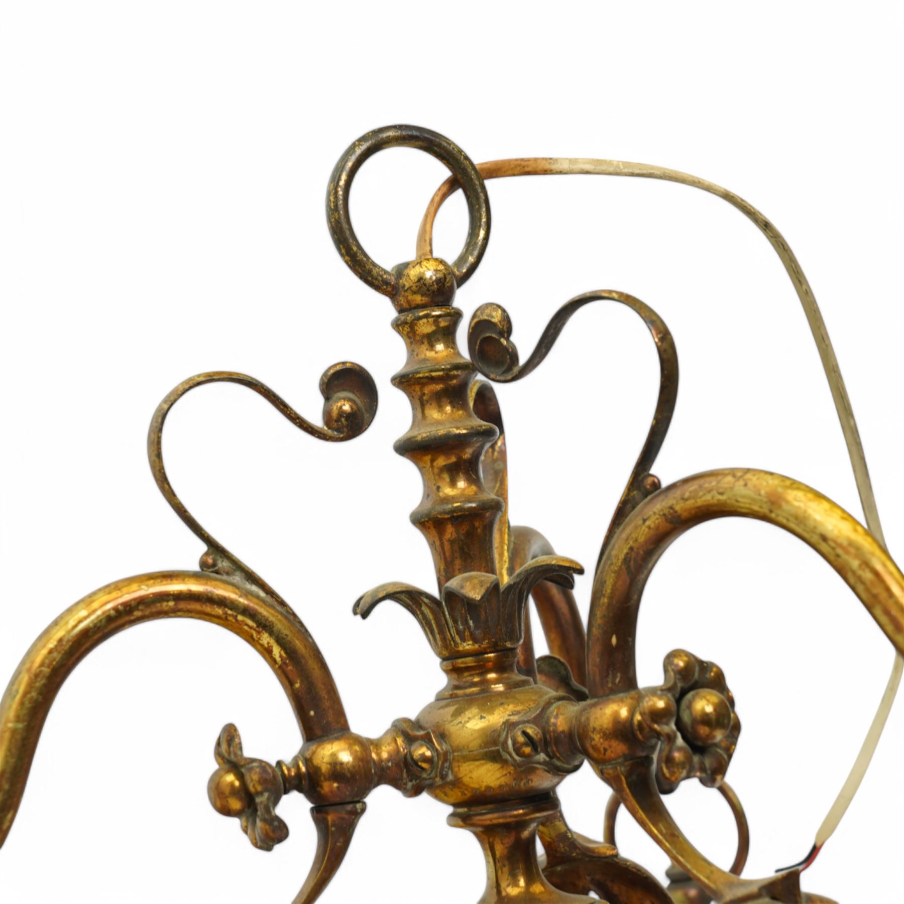 Early 20th century brass three-light chandelier, with Art Nouveau style curved and foliate ornamentation, the hanging branches formed as budding flowers with petal adornments, the bulb holders having pierced decoration to bowls, H43cm; together with two wall sconces