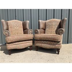 Pair of leather and fabric wing back chairs