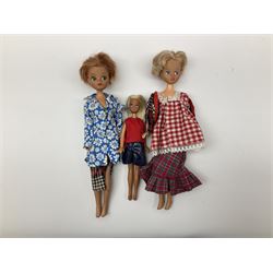 The World of Barbie Double Doll Case containing a quantity of assorted doll's clothing; together with two large and one small fashion dolls.