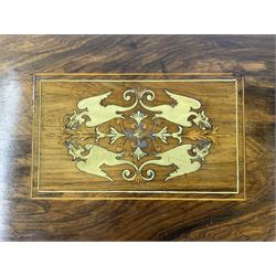 Edwardian inlaid mahogany games or work table, rectangular fold-over top inlaid with stylised dragon ivorine decoration and stringing, fitted with one long flanked by four small drawers over sewing compartment drawer, raised on square tapering supports with castors
