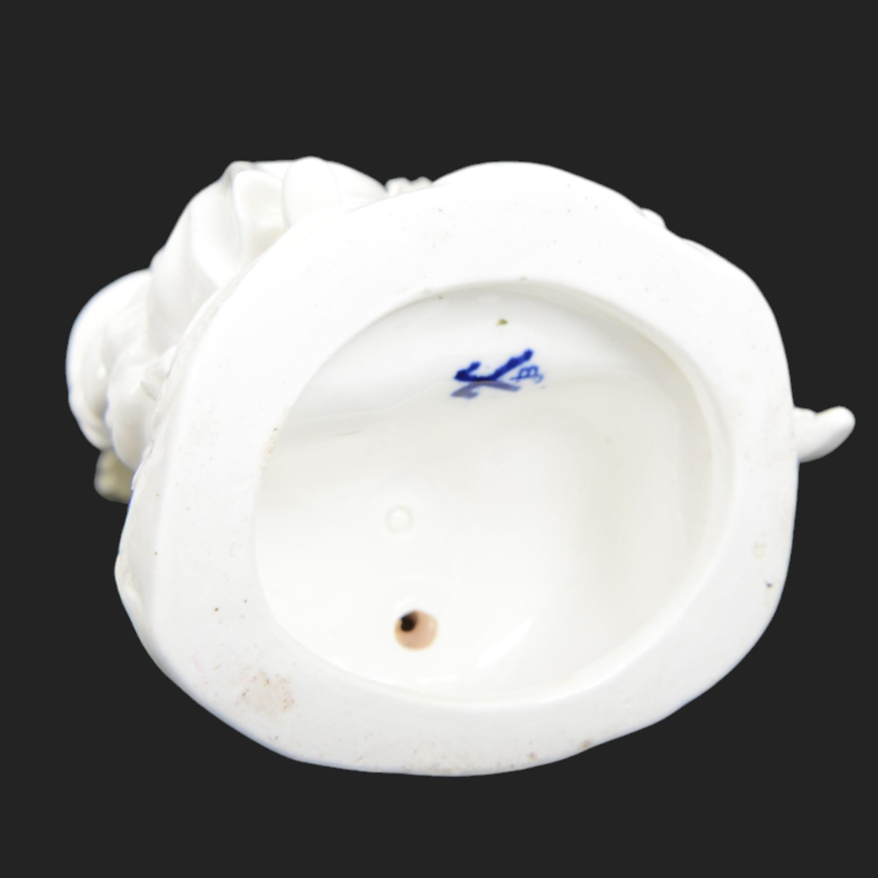 Pair of 19th century Meissen style Blanc de Chine figural candlesticks, each depicting children gathering flowers, with spurious mark beneath, H21cm