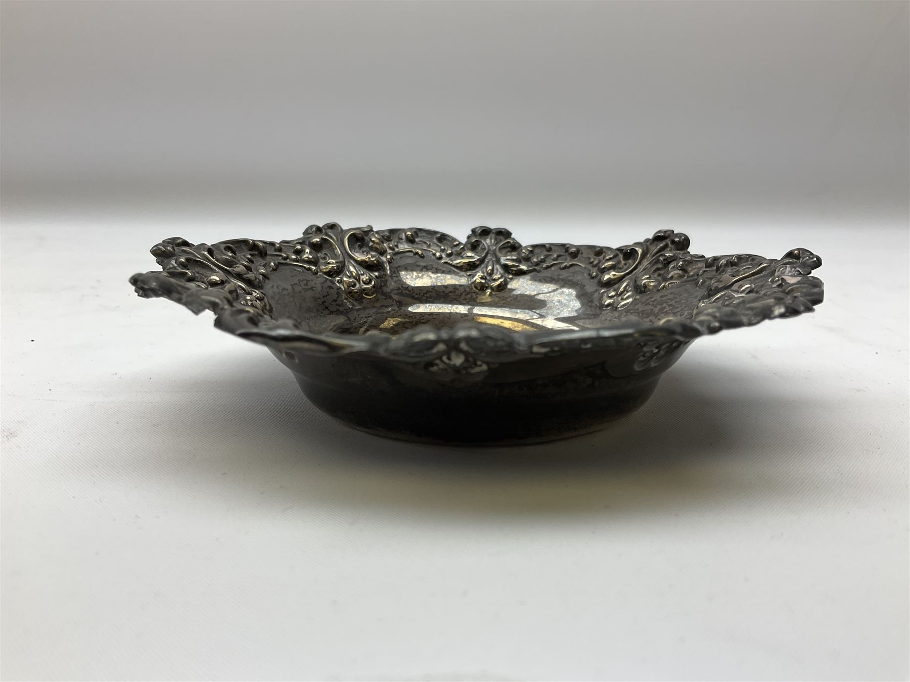 Small silver dish with repousse scrolling edge, stamped Sterling, together with a pair of Danish silver spoons, approximate total weight 61.4 grams