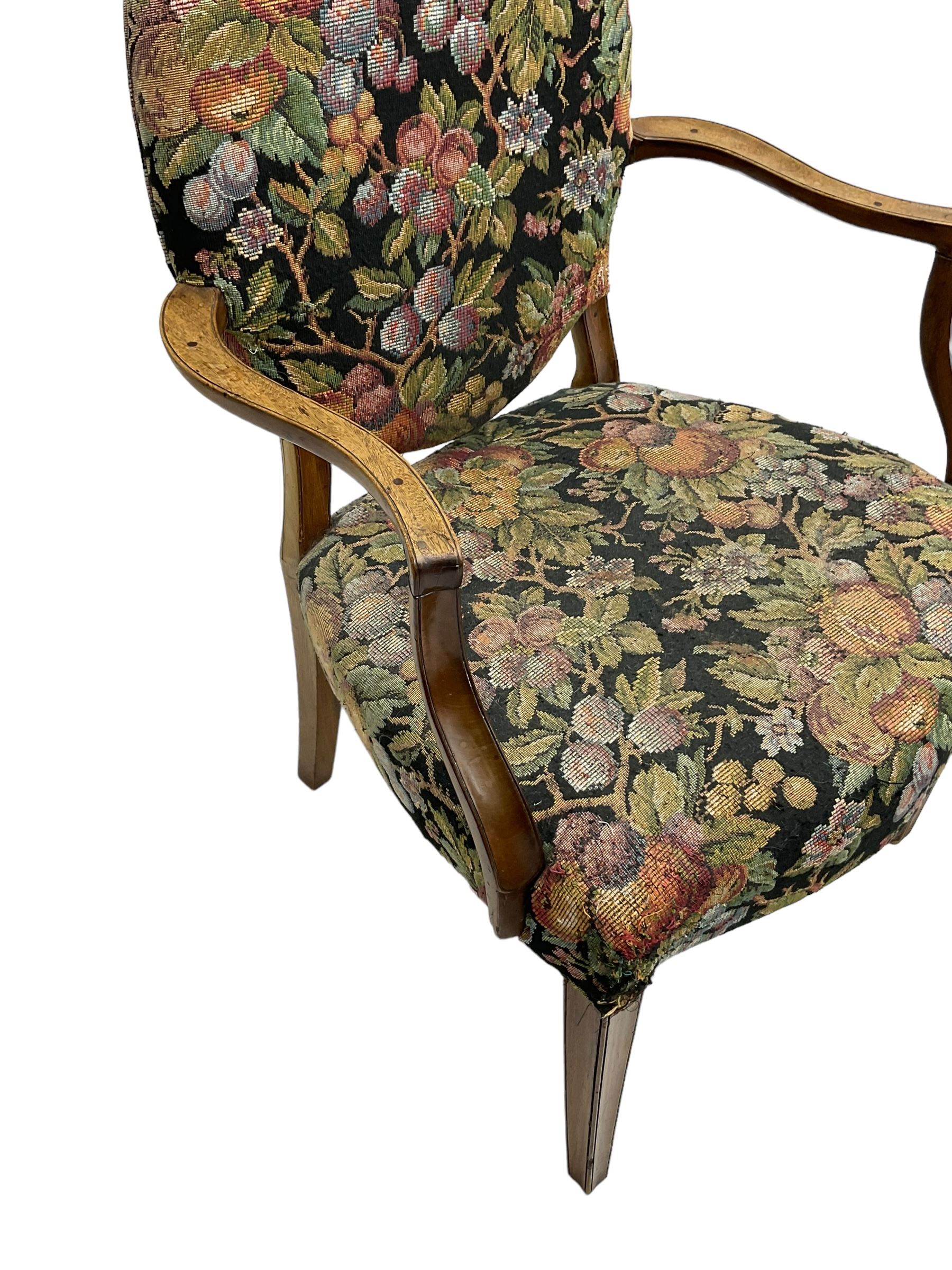 Pair of George III mahogany framed open armchairs, oval back and serpentine seat upholstered in fruit and foliage patterned fabric, shaped and moulded arms and arm supports, on square tapering moulded front supports 