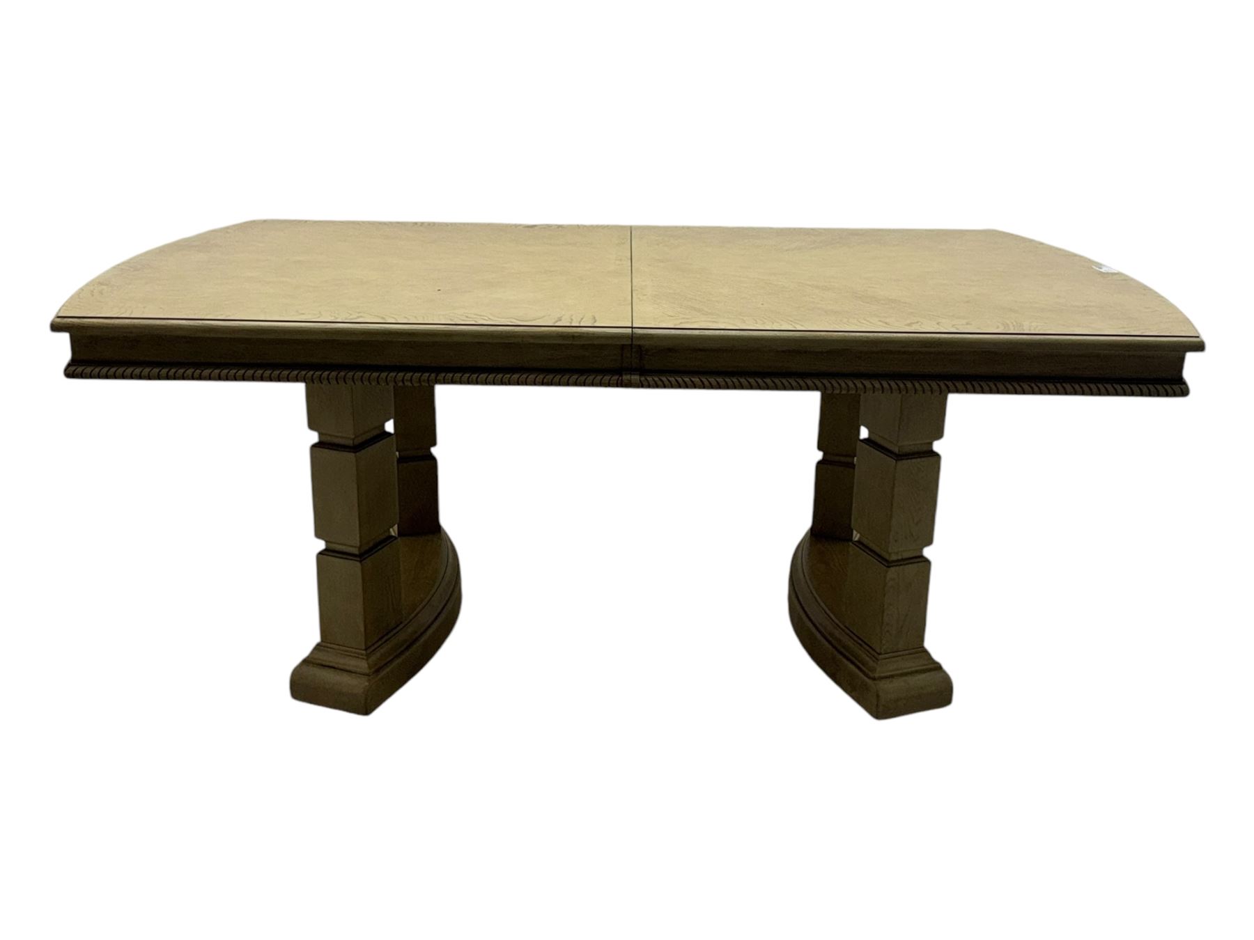 Brunswick - washed oak finish extending dining table, rectangular top with curved ends and carved frieze, central extension leaf, raised on twin pedestals with arched plinth bases and square-sectioned column supports; set of eight (6+2) high-back dining chairs upholstered in beige velvet fabric