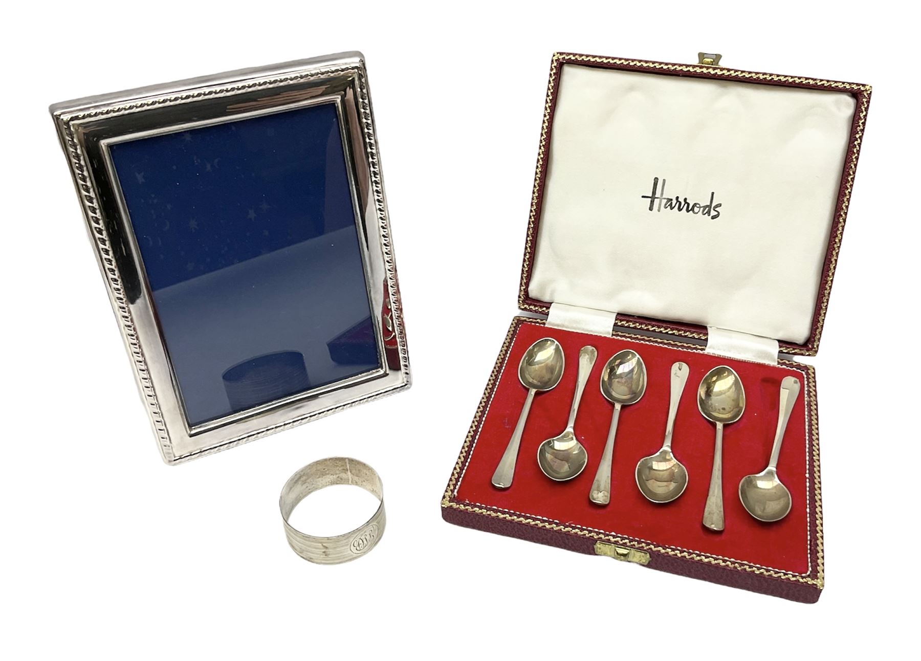 Set of six 1960's silver coffee spoons, hallmarked Sheffield, contained within a fitted case with interior inscribed Harrods, together with a silver napkin ring, hallmarked Birmingham, and a silver plated photograph frame, approximate silver weight 68.4 grams