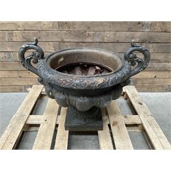 Victorian design ornate cast iron centrepiece urn, featuring two handles, raised on footed base