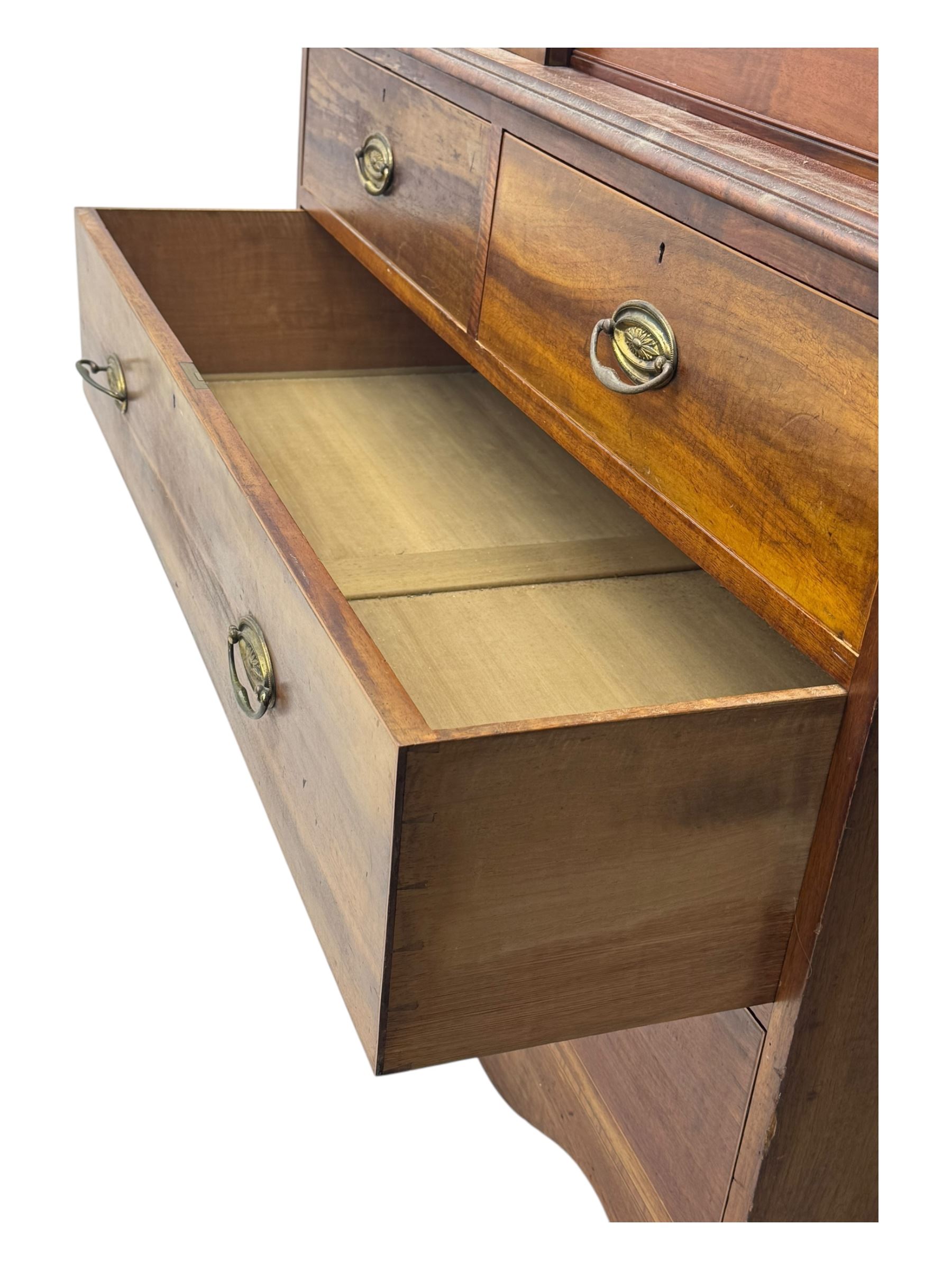 George III mahogany linen press cupboard, projecting moulded cornice over two panelled doors, the interior fitted with two slides and shelf, two short and two long drawers below, shaped apron over bracket feet 