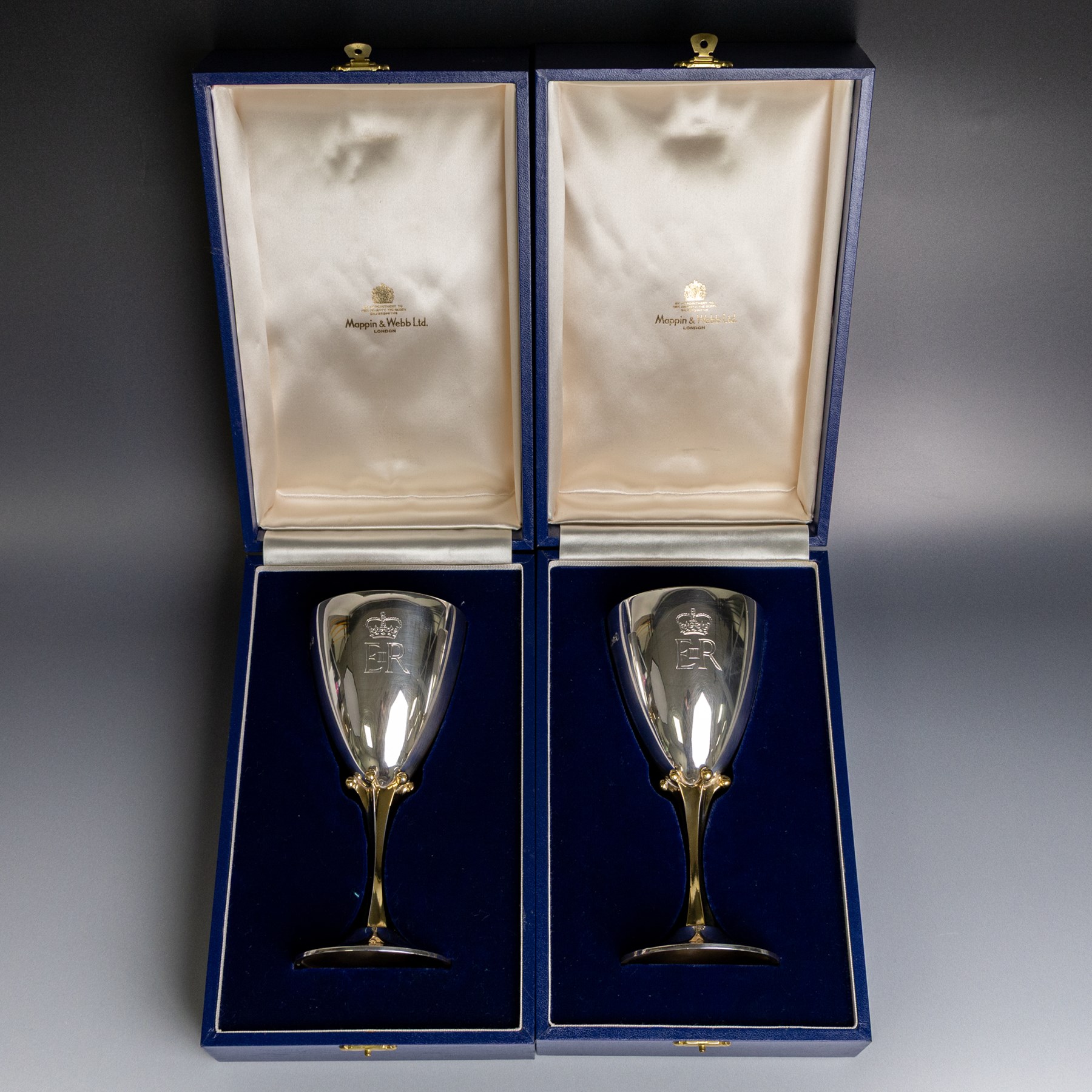 Pair of limited edition commemorative silver goblets, each engraved with HRH Queen Elizabeth's Royal cypher, the bowls with gilt interior and upon a parcel gilt stem, the circular foot engraved 'The Queen's Silver Jubilee 1952-1977', both hallmarked Mappin & Webb Ltd, Sheffield 1977, limited edition numbers 267 & 268/2500, boxed, H17cm