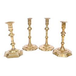 pair of 18th century brass candlesticks, each having slender knopped stems and scalloped petal base, together with two other brass candlesticks, H21cm