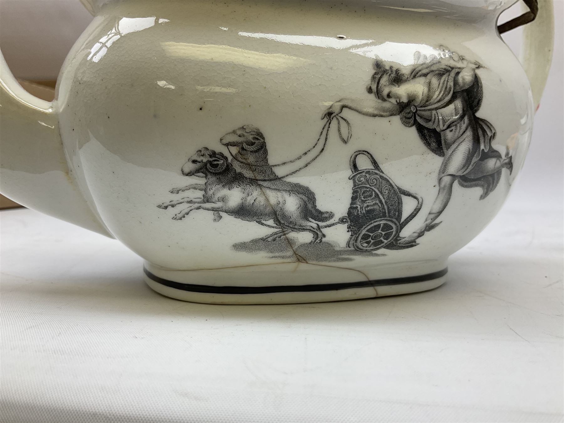 Early 19th century Staffordshire bat printed part tea service, decorated in black after Adam Buck with scenes of mother and child and other varying classical style scenes, within black bands, comprising teapot, slop bowl, jug, seven teacups and five saucers 